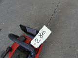 a red toy car with a sign attached to it
