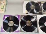 four black vinyl records sitting on a white table