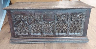 a wooden chest sitting on a hard wood floor
