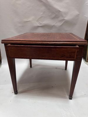 a small wooden table with a drawer on top of it