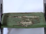 a wooden bench with a green seat on it