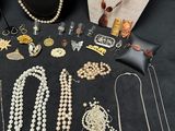 many necklaces and bracelets on display on a table