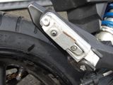 a close up of a motorcycle tire with a chain attached to it