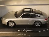 a silver toy car on display in a glass case