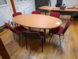 a table and chairs in a room with wood flooring