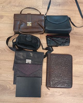 many different types of purses and wallets laid out on the floor
