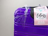 a purple suitcase that has a tag on it