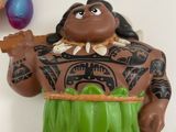 a toy figurine of a man with a hula skirt holding a banana