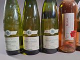 bottles of wine are lined up in a row on a table