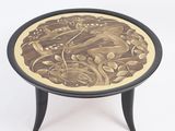 a black and gold table with a picture of a bird on it