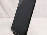 the back of a black tablet computer sitting on top of a white surface