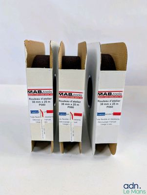 three boxes of wax on a white surface with a white background