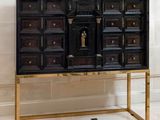 an image of a black and gold cabinet in a room
