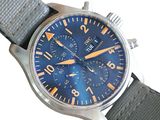 a close up of a watch with a blue dial