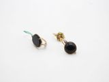 a pair of black onyx earrings with gold accents on a white background