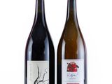 two bottles of wine sitting next to each other on a white surface