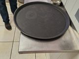 a man standing in a kitchen with a pan on the counter