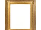an antique gold frame on a white wall