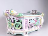 a decorative box with flowers on it on a white surface
