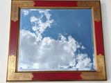 a picture of a mirror hanging on the wall