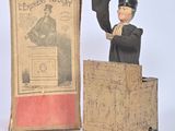 a statue of a man standing at a podium in front of a book