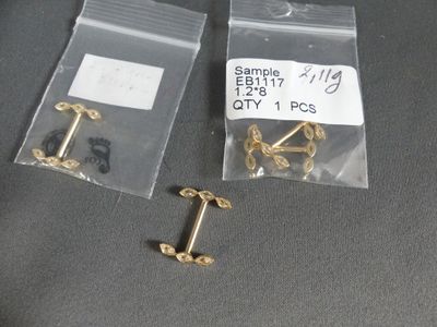 two bags of screws and a chain on a table