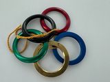 several different colored rings are tied together on a white surface
