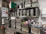 many pots and pans on the shelves in the kitchen
