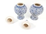 two blue and white vases sitting next to each other