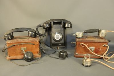 two old telephones sitting next to each other on a table