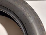 a tire on the side of a white wall