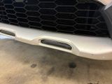 a close up of the front of a car with a grille