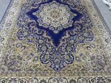 a blue and gold rug on the floor in a room