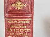 a red book sitting on top of a glass table