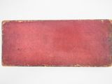 a red book sitting on top of a white table