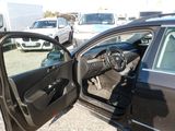 a black car with its door open in a parking lot