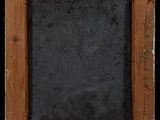 an old wooden frame with a chalk board in it