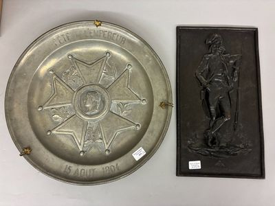 a silver plate with a picture of a man on it and a plaque with a star on it