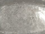 a silver tray with a handle on a white table