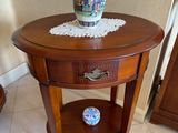 a small table with a vase on top of it