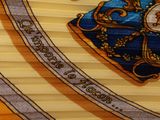 a close up of a yellow and blue tie with a picture on it
