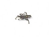 a silver brooch with a dragonfly on it