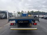 a picture of a flatbed truck parked in a parking lot