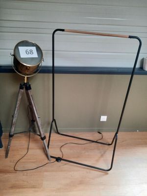 a lamp that is on a tripod stand next to a lamp