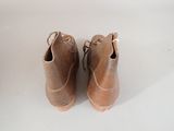 a pair of brown shoes sitting on a white surface