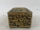 an antique brass box with a design of birds and flowers on it