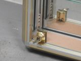 a close up of a glass display case with a door handle