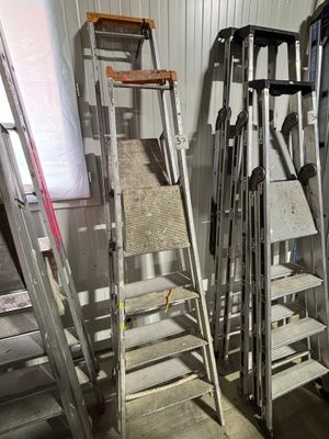 many ladders that are leaning against the wall