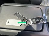 a car key that is attached to a car door handle