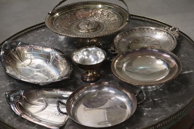 a table with a lot of silver dishes on it